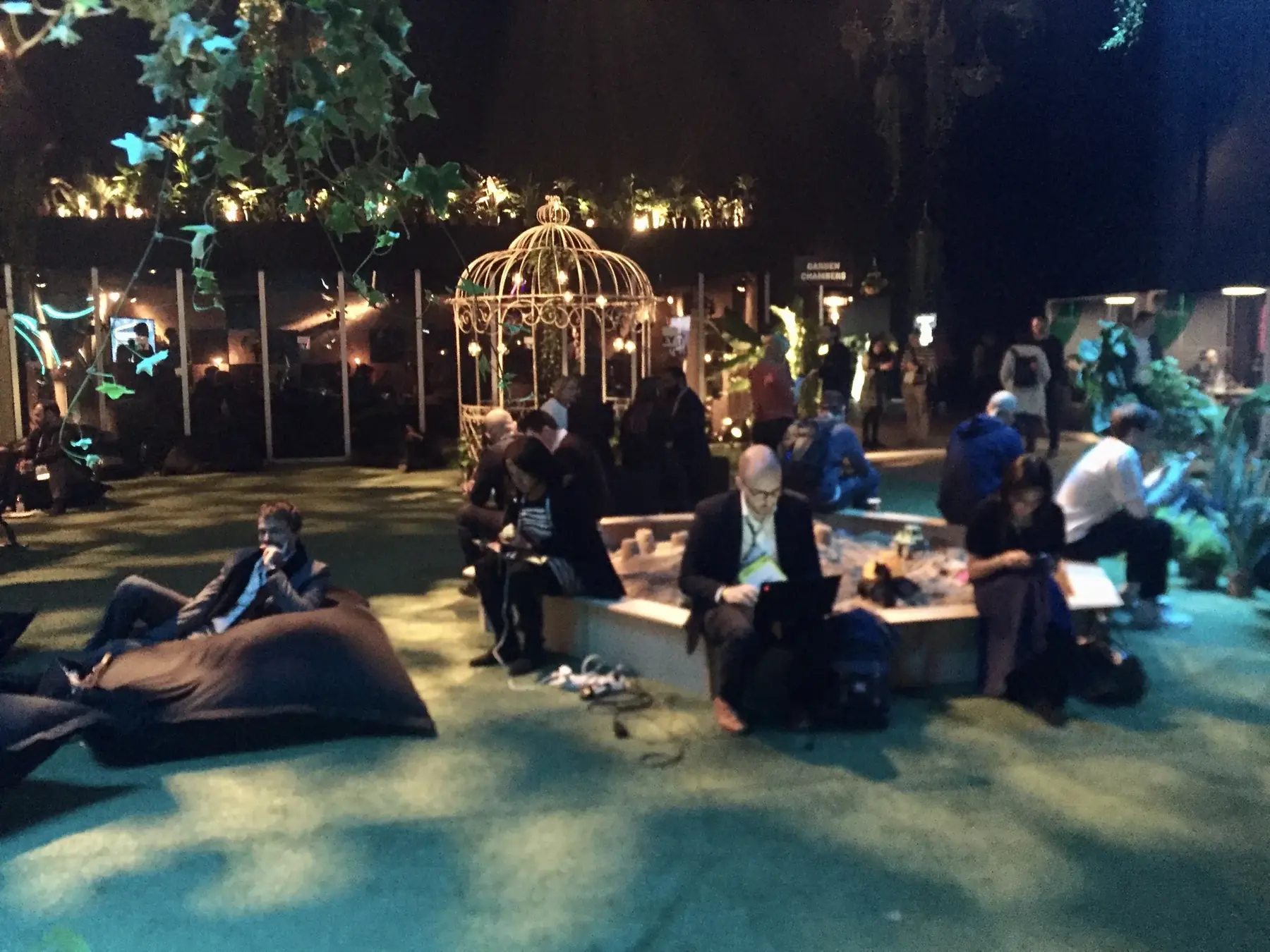 Tuxed up business people ignoring the sandbox and doing boring grown-up stuff instead