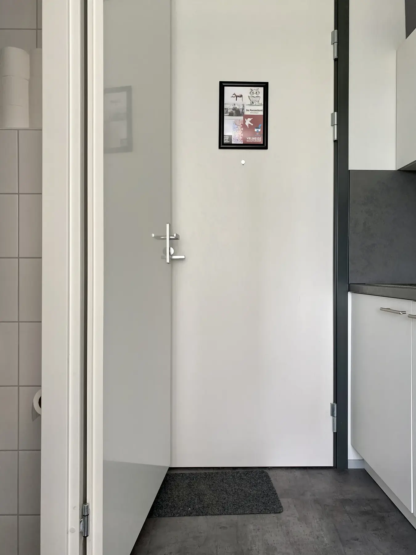 A wide-open bathroom door successfully blocks the front door from opening