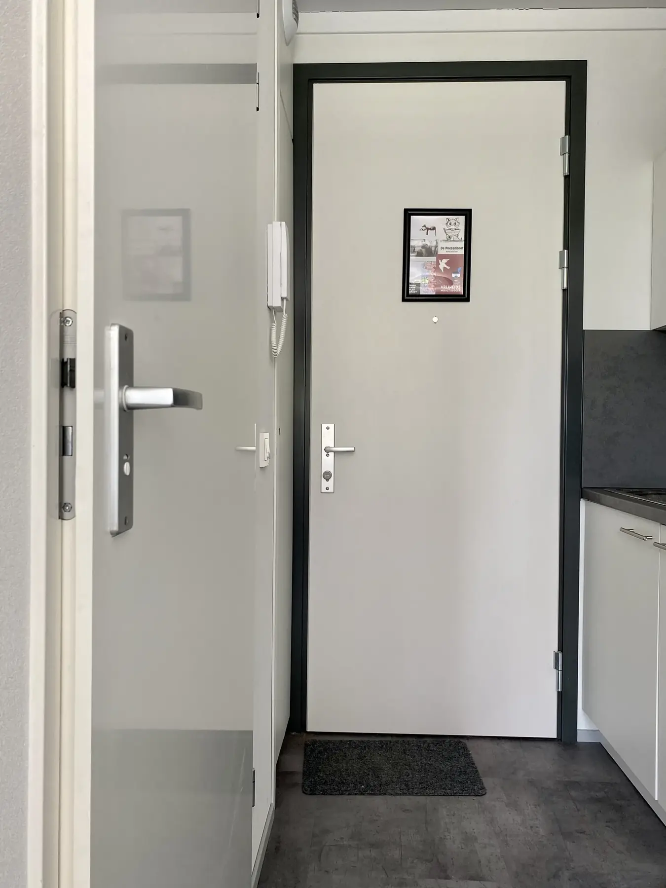 The front and bathroom doors both open towards the narrow kitchen-corridor